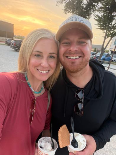 Patrick and Taren Lowe, founders of Wrangler Hauling & Disposal, smiling side by side outdoors at sunset