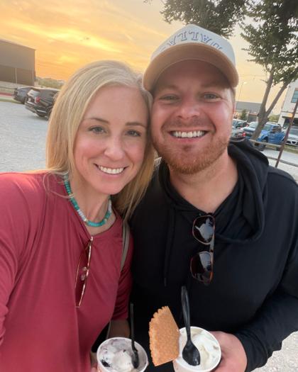Patrick and Taren Lowe, founders of Wrangler Hauling & Disposal, smiling side by side outdoors at sunset